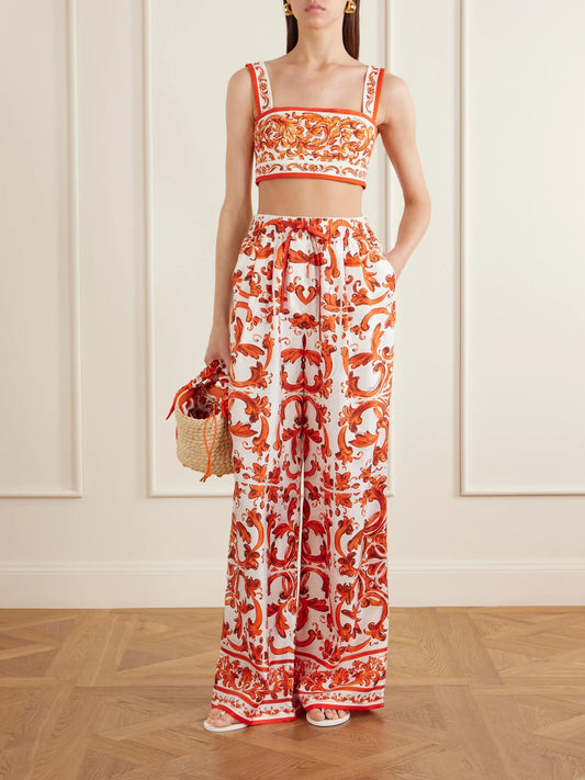 Image of a model wearing Tops. Product name - Cropped Printed Woven Top in Orange colour by brand - Dolce & Gabbana