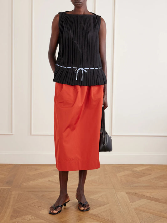 Image of a model wearing Tops. Product name - Belted Pleated Poplin Blouse in Black colour by brand - TOTEME