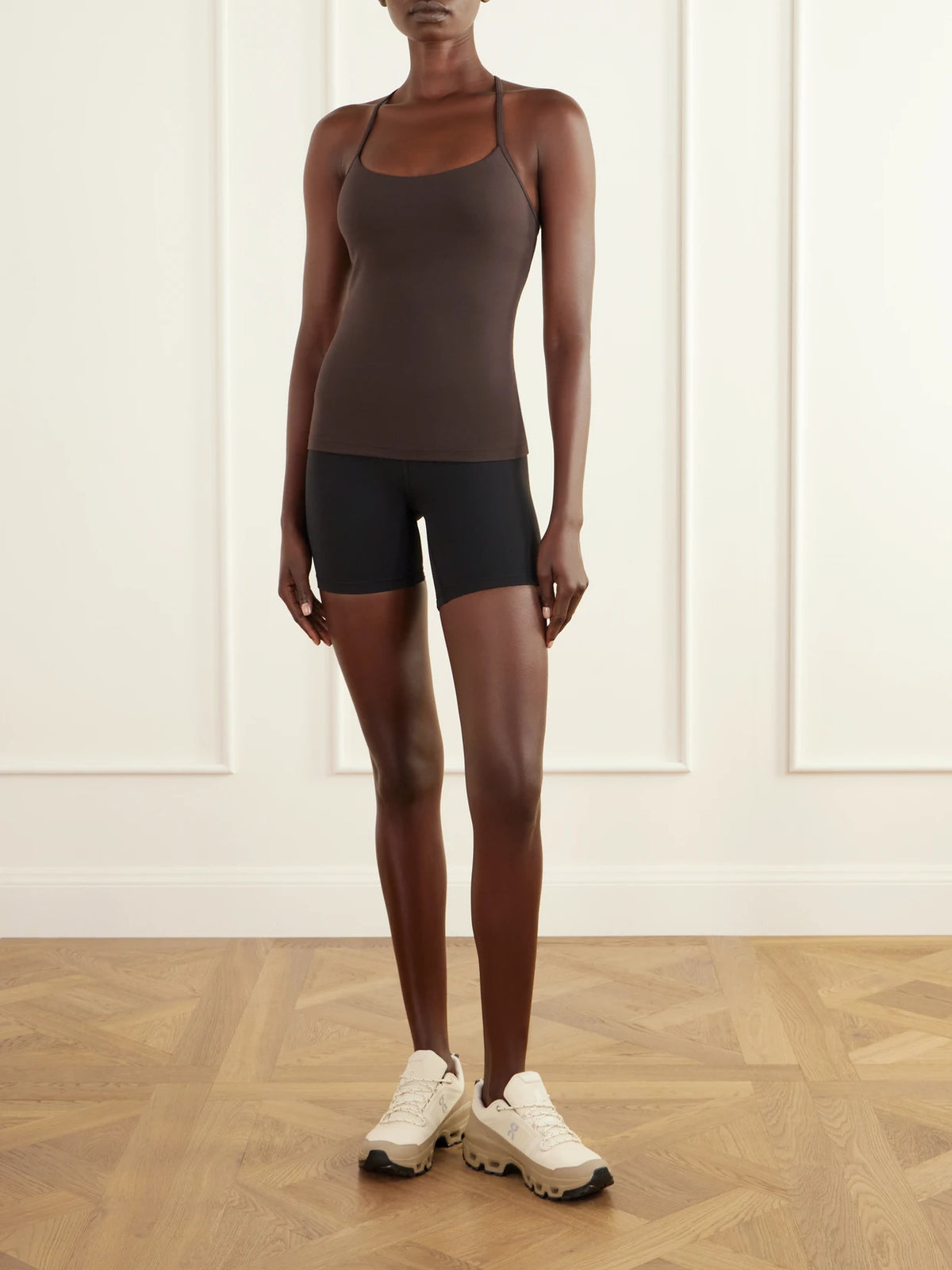 Image of a model wearing Tops. Product name - Flow Y Light Support Nulu Tank in Brown colour by brand - lululemon