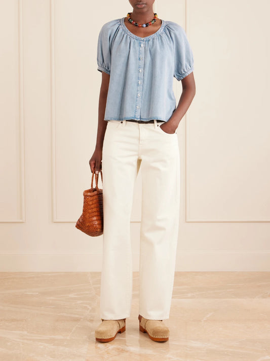 Image of a model wearing Tops. Product name - The Resort Cotton And Lyocell-blend Chambray Blouse in Blue colour by brand - FRAME