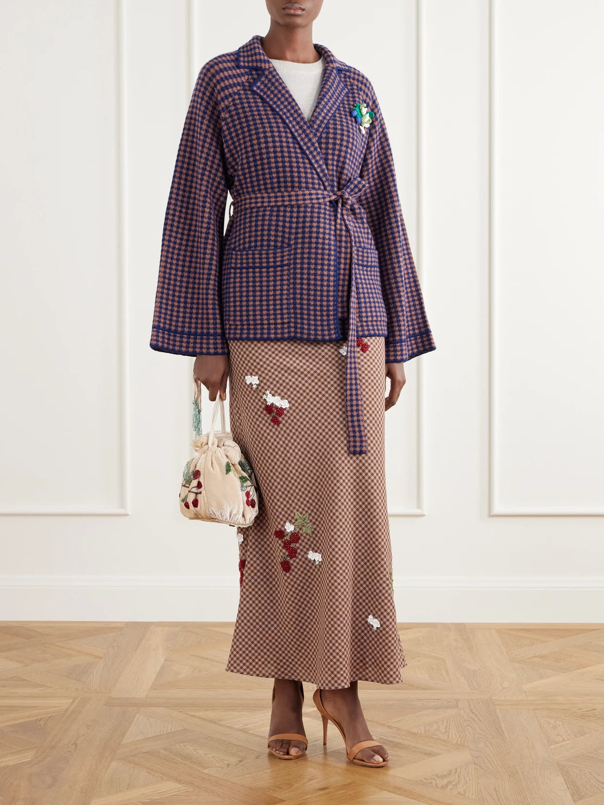 Image of a model wearing Skirts. Product name - Chuck Belted Bead-embellished Checked Wool Maxi Skirt in Brown colour by brand - BERNADETTE
