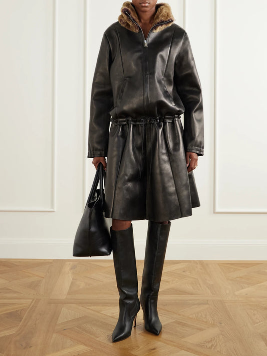 Image of a model wearing Skirts. Product name - Naomi Paneled Leather Midi Skirt in Black colour by brand - STOULS