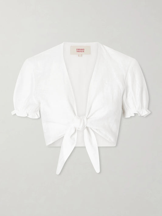Image of a model wearing Tops. Product name - Poppy Knotted Linen Cropped Top in White colour by brand - Emporio Sirenuse