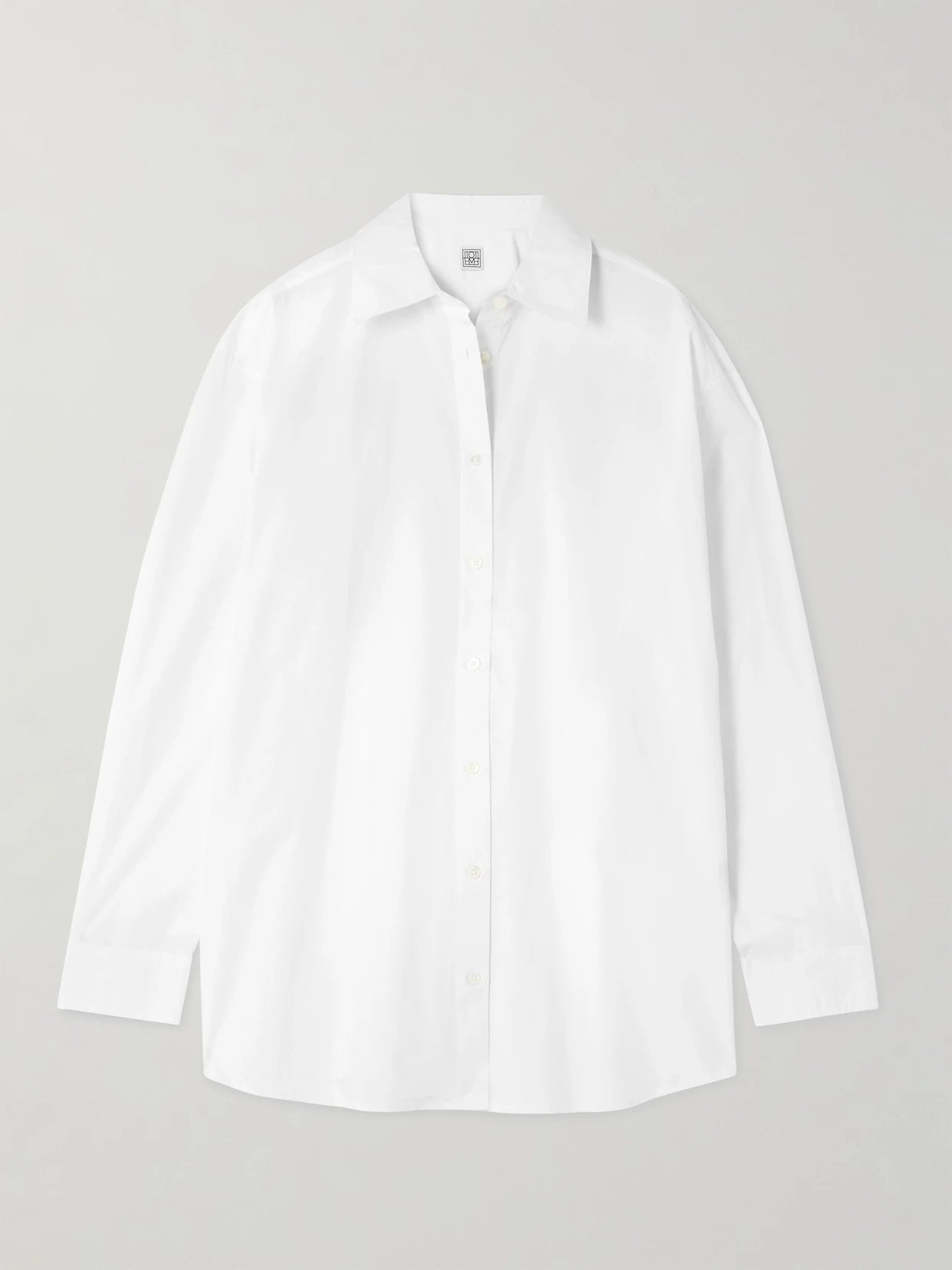 Image of a model wearing Tops. Product name - Garderob Organic Cotton-poplin Shirt in White colour by brand - TOTEME