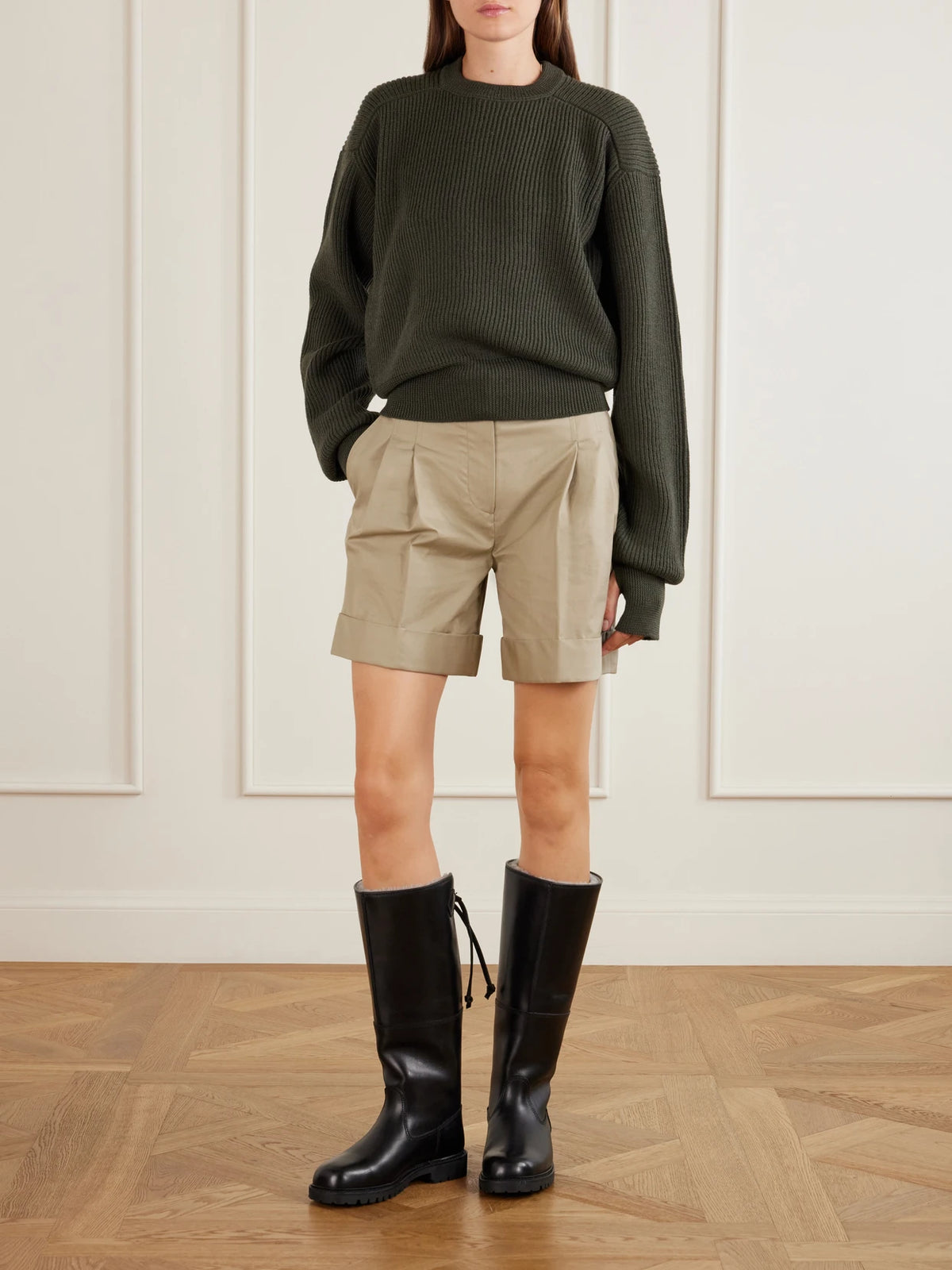 Image of a model wearing Outerwear. Product name - Ribbed Virgin Wool Sweater in Army green colour by brand - RIER