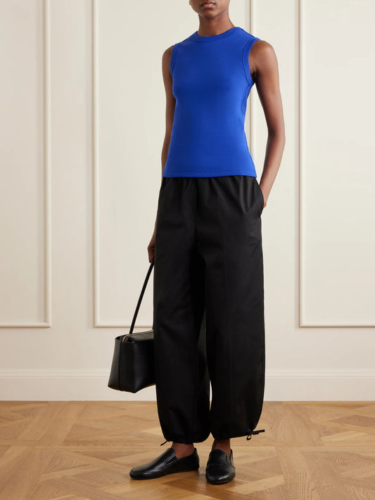 Image of a model wearing Tops. Product name - Esmé Ribbed Organic Cotton-jersey Tank in Blue colour by brand - FLORE FLORE