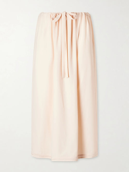 Image of a model wearing Skirts. Product name - Silk Midi Skirt in Baby pink colour by brand - TOTEME