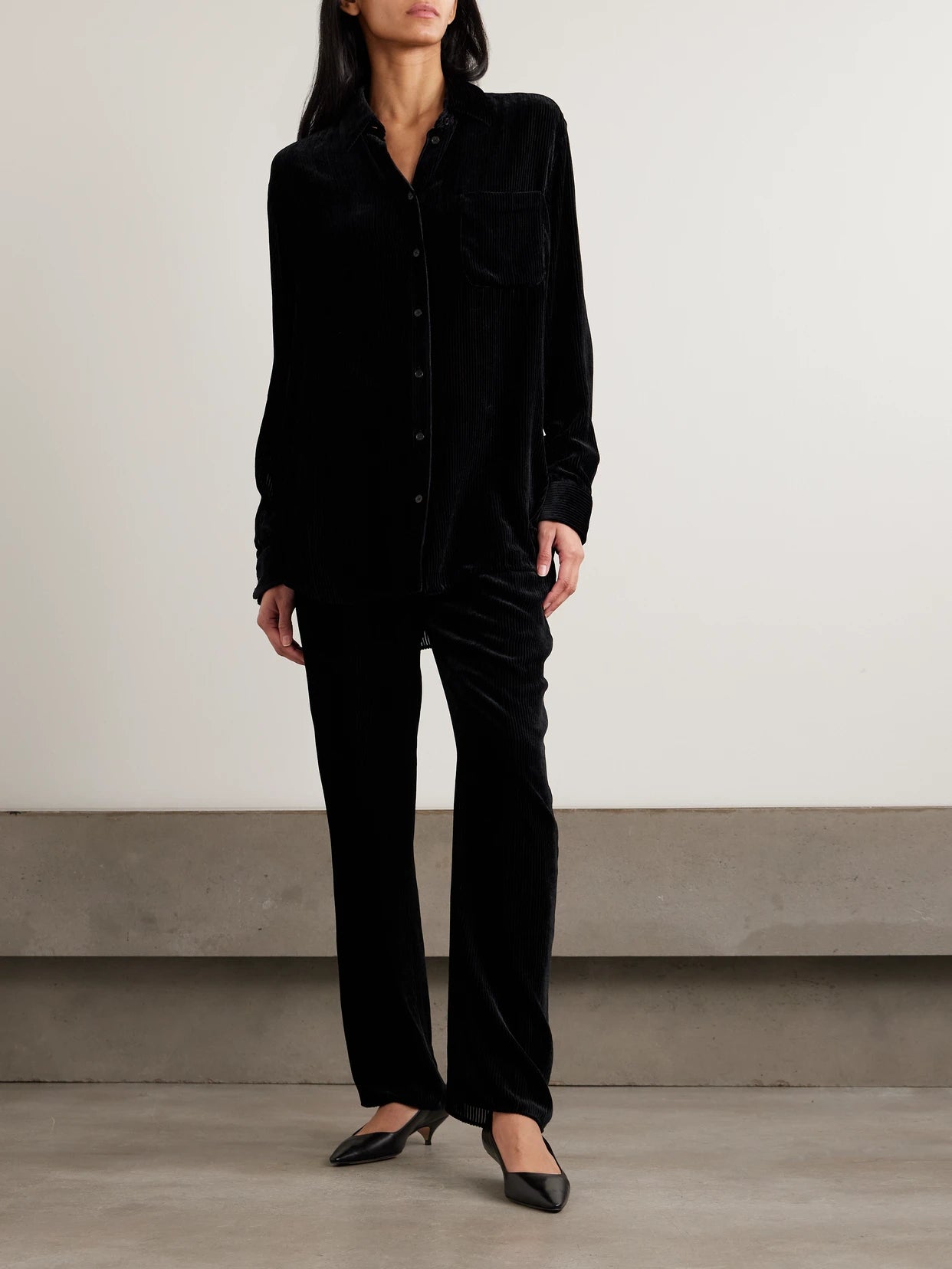 Image of a model wearing Tops. Product name - Gavina Ribbed Velvet Shirt in Black colour by brand - The Row