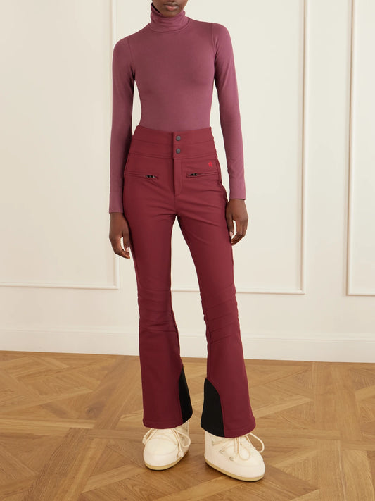 Image of a model wearing Pants. Product name - Aurora Embroidered Stretch-shell Flared Ski Pants in Burgundy colour by brand - Perfect Moment