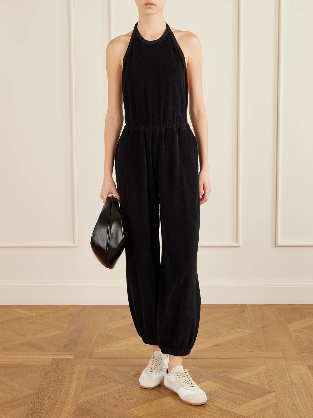 Image of Bodysuits. Product name - Anna Cotton-blend Terry Halterneck Jumpsuit in Black colour by brand - Suzie Kondi