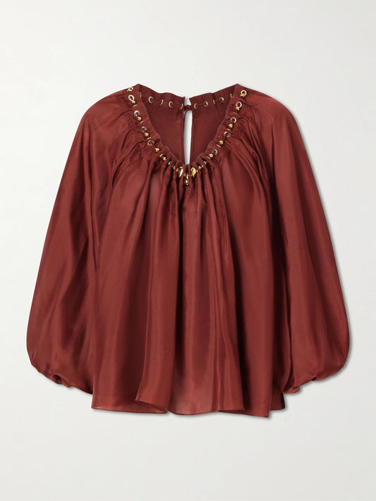 Image of a model wearing Tops. Product name - Aster Gathered Beaded Silk-satin Blouse in Burgundy colour by brand - Zimmermann