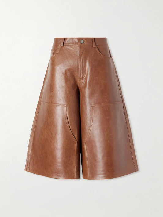 Image of a model wearing Shorts. Product name - Legacy Leather Wide-leg Shorts in Brown colour by brand - Haikure
