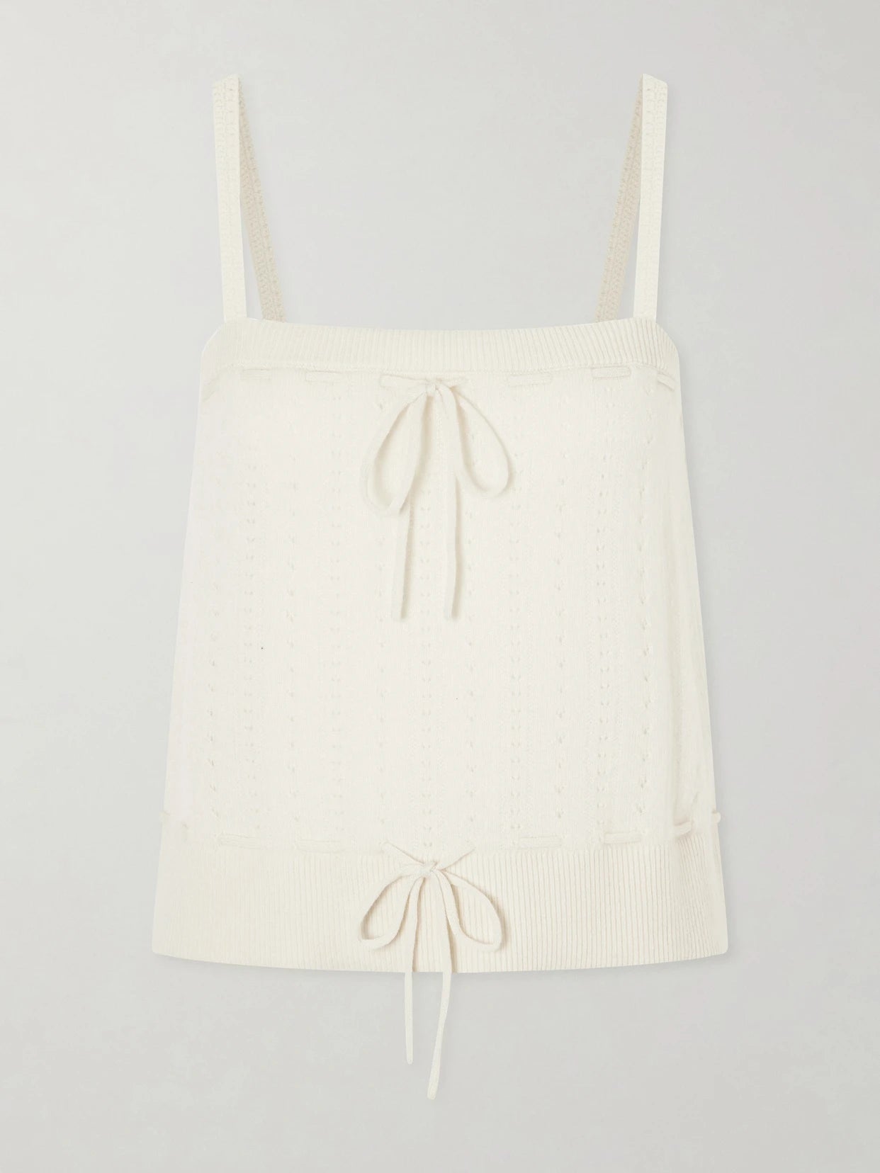 Image of a model wearing Tops. Product name - Charm Knotted Knit Cashmere Tank in Cream colour by brand - FRAME