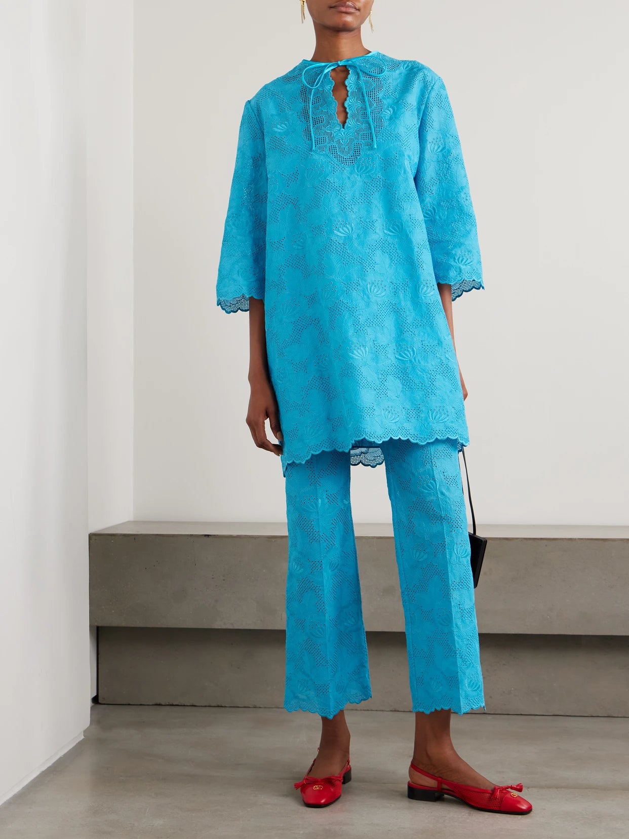 Image of a model wearing Pants. Product name - Broderie Anglaise Cotton Bootcut Pants in Blue colour by brand - Valentino Garavani