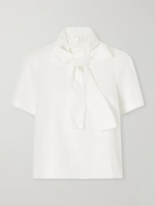 Image of a model wearing Tops. Product name - Bow-detailed Linen Blouse in White colour by brand - SHUSHU/TONG