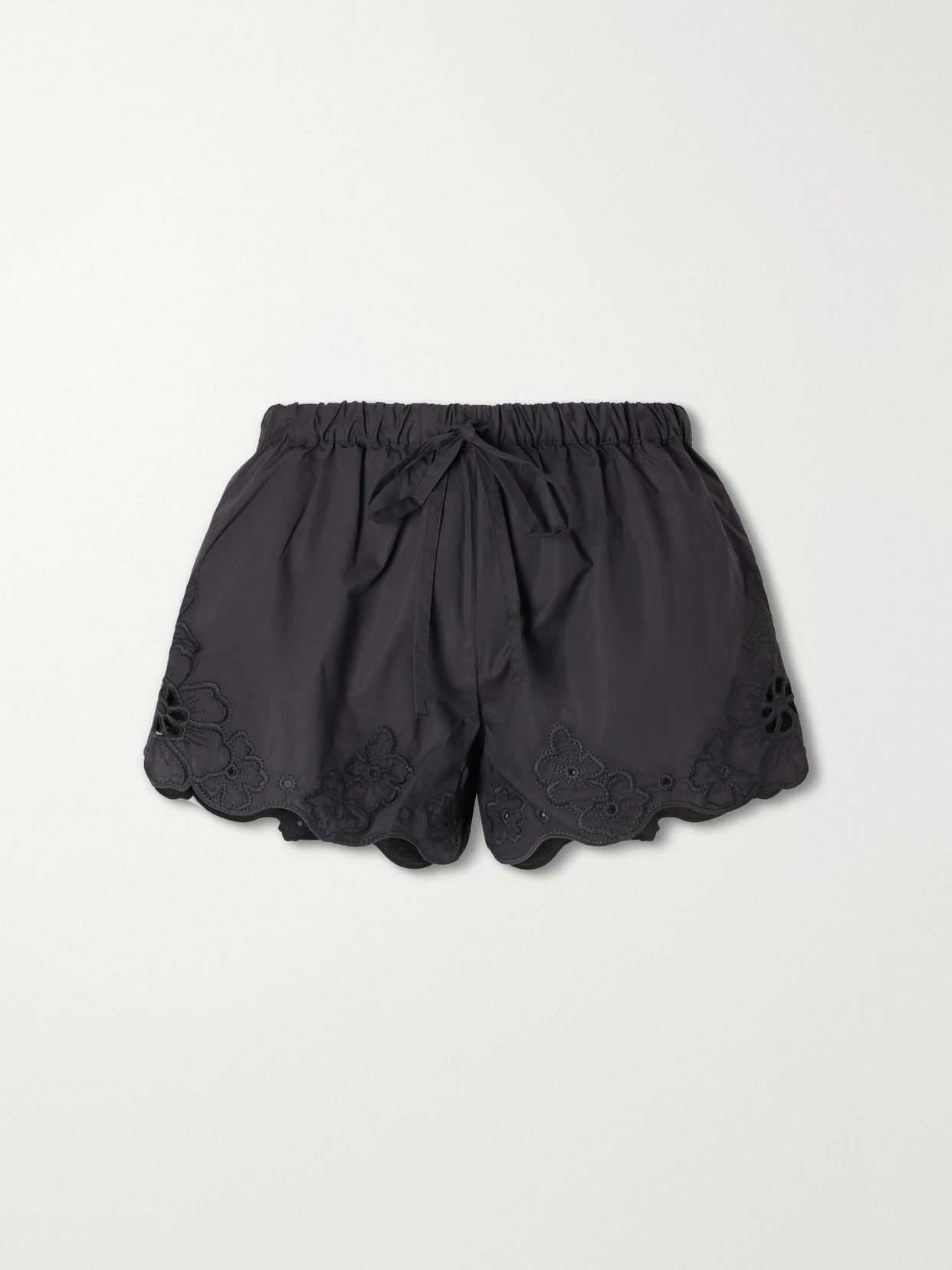 Image of a model wearing Shorts. Product name - Klara Broderie-anglaise Cotton Mini Shorts in Black colour by brand - SIR.