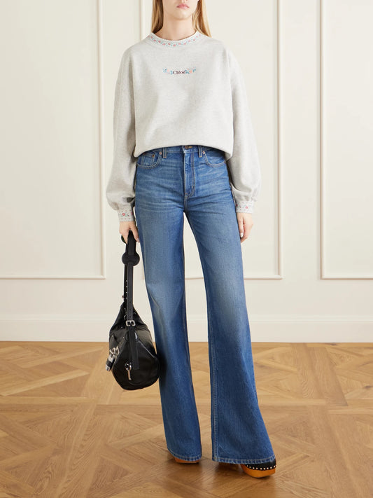 Image of a model wearing Tops. Product name - Logo-embroidered Scalloped Cotton-jersey Sweatshirt in Gray colour by brand - Chloé