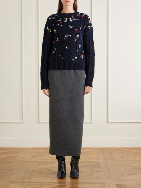 Image of a model wearing Outerwear. Product name - Elias Embroidered Cable-knit Cashmere Sweater in Navy colour by brand - KHAITE