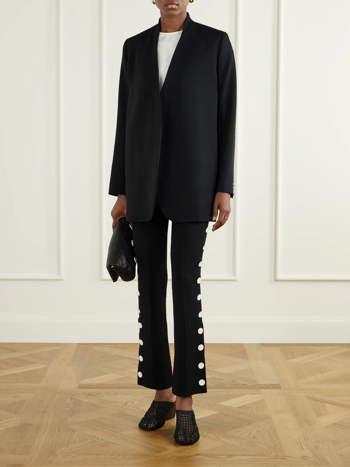 Image of a model wearing Pants. Product name - Martina Button-embellished Stretch-jersey Skinny Pants in Black, Burgundy colour by brand - Proenza Schouler