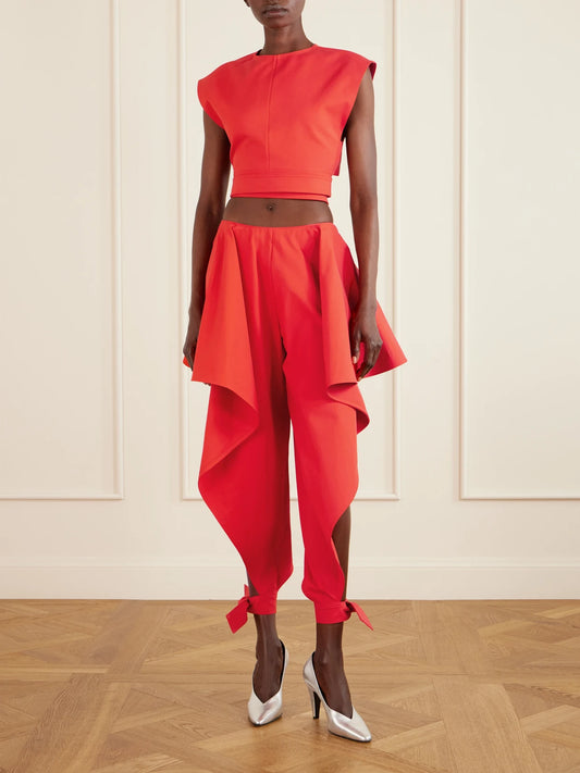 Image of a model wearing Pants. Product name - Paneled Ruffled Cotton-gabardine Wide-leg Pants in Red colour by brand - Alaïa