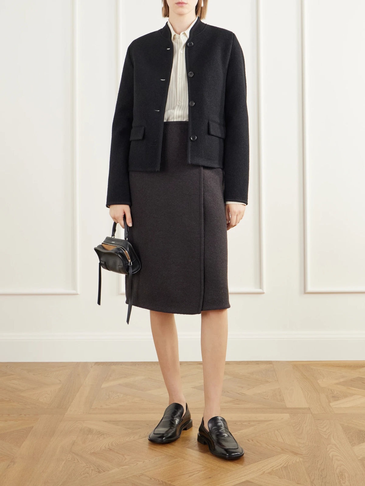 Image of a model wearing Skirts. Product name - Walker Felted Wool-fleece Midi Skirt in Black colour by brand - RIER