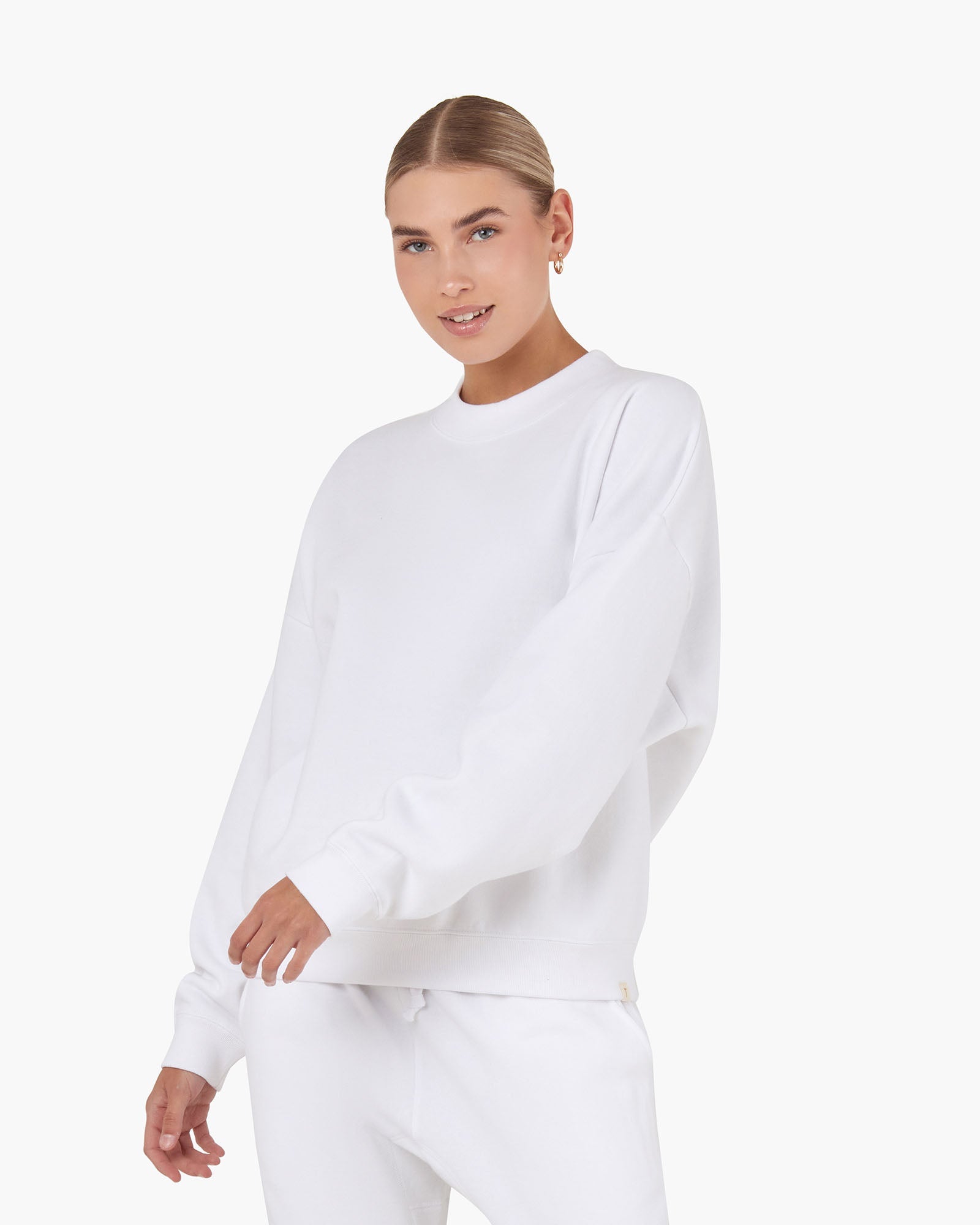 Image of a model wearing Outerwear. Productname: Core Fleece Crewneck White in White colour by brand - TKEES