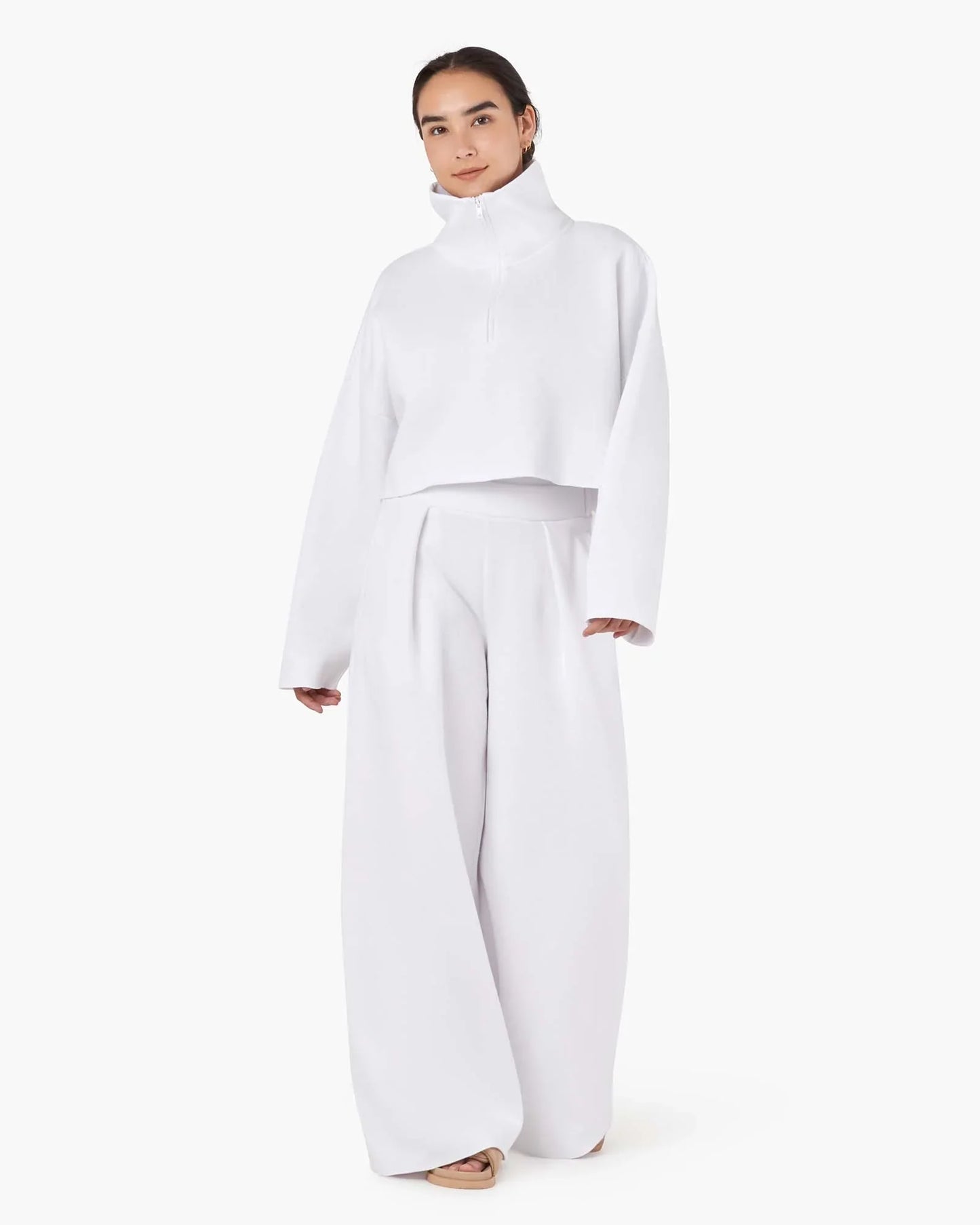 Image of a model wearing Outerwear. Productname: Core Fleece Cropped Half Zip White in White colour by brand - TKEES