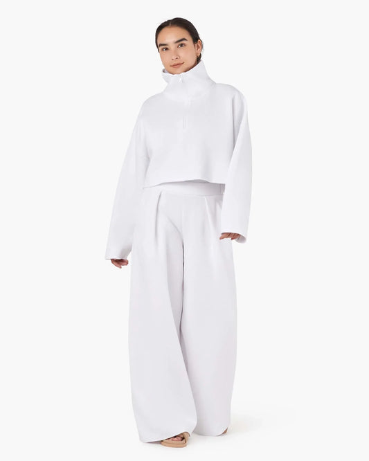 Image of a model wearing Outerwear. Productname: Core Fleece Cropped Half Zip White in White colour by brand - TKEES