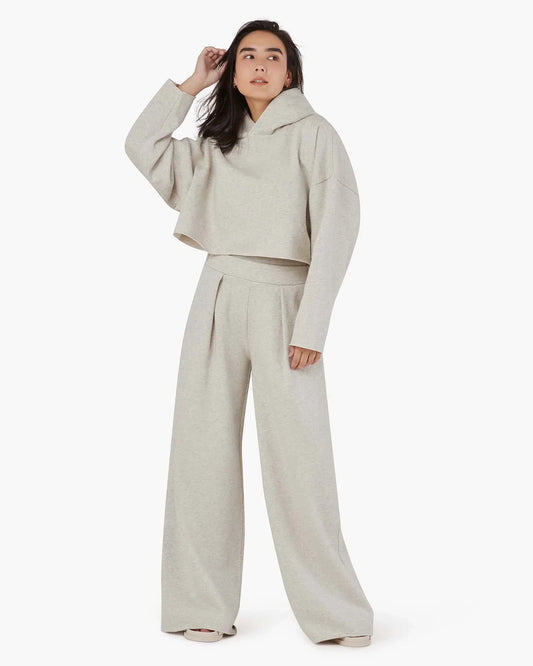 Image of a model wearing Outerwear. Productname: Core Fleece Cropped Hoodie Eggshell Mix in Eggshell Mix colour by brand - TKEES
