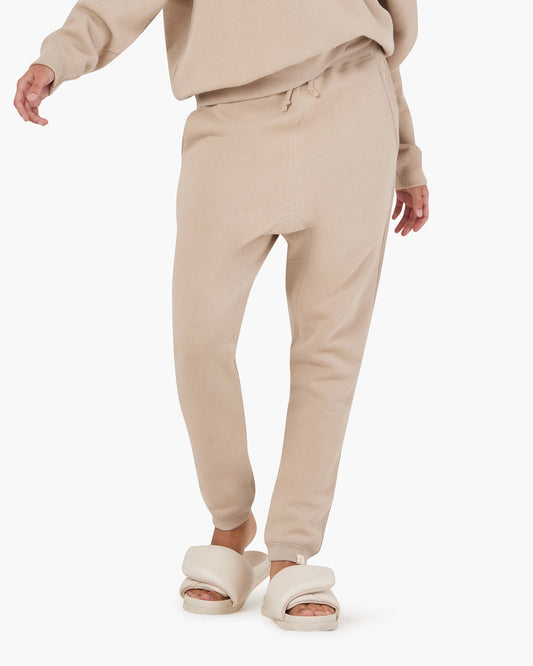 Image of a model wearing Outerwear. Productname: Core Fleece Jogger Sand in Sand colour by brand - TKEES