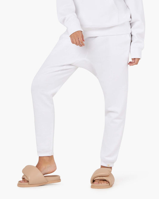 Image of a model wearing Outerwear. Productname: Core Fleece Jogger White in White colour by brand - TKEES