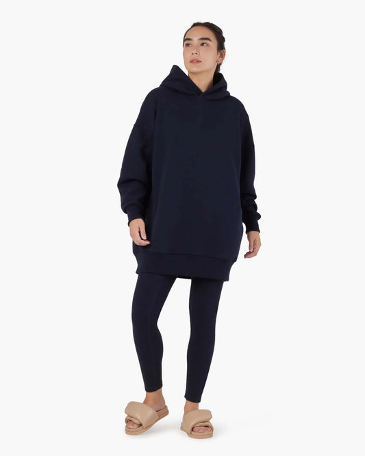 Image of a model wearing Outerwear. Productname: Core Fleece Oversized Hoodie Midnight Navy in Midnight Navy colour by brand - TKEES