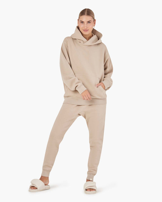Image of a model wearing Outerwear. Productname: Core Fleece Sport Jogger Sand in Sand colour by brand - TKEES