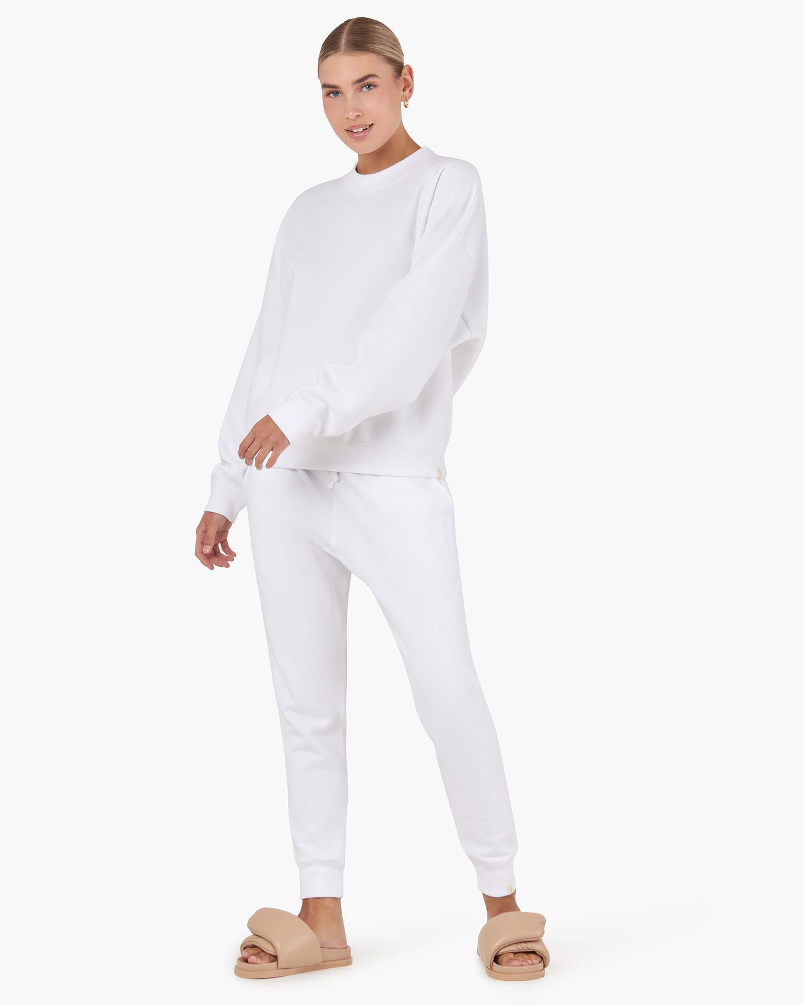 Image of a model wearing Outerwear. Productname: Core Fleece Sport Jogger White in White colour by brand - TKEES
