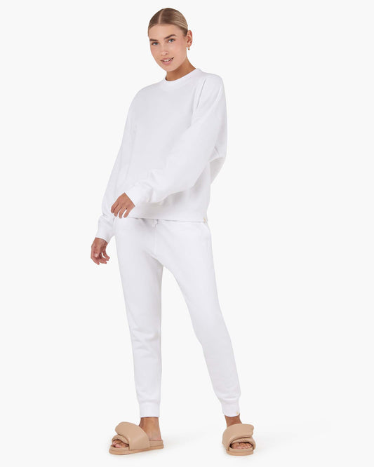 Image of a model wearing Outerwear. Productname: Core Fleece Sport Jogger White in White colour by brand - TKEES