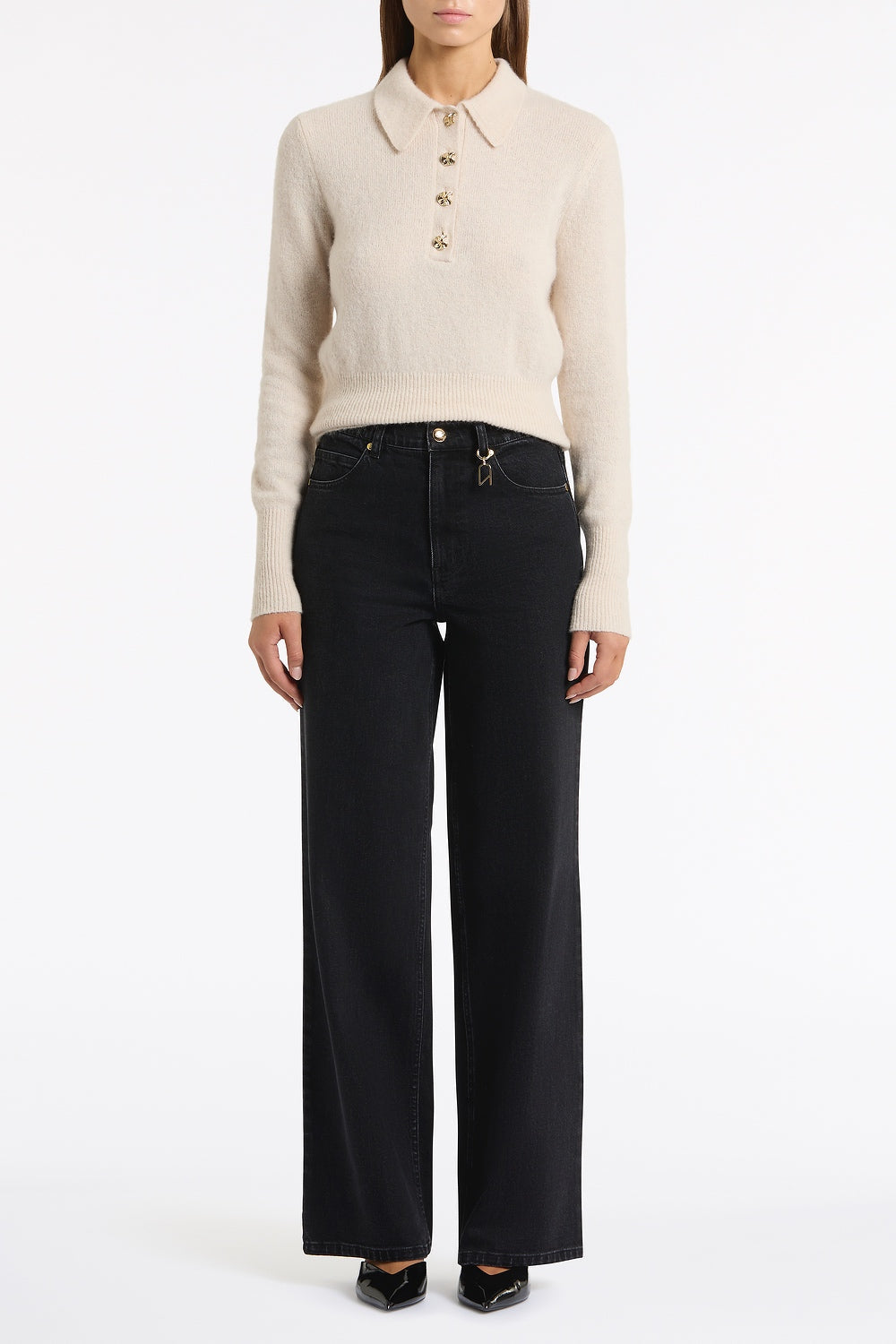 Image of a model wearing Pants. Product name - Washed Black Denim Wide Leg Pant in Black colour by brand - Carla Zampatti