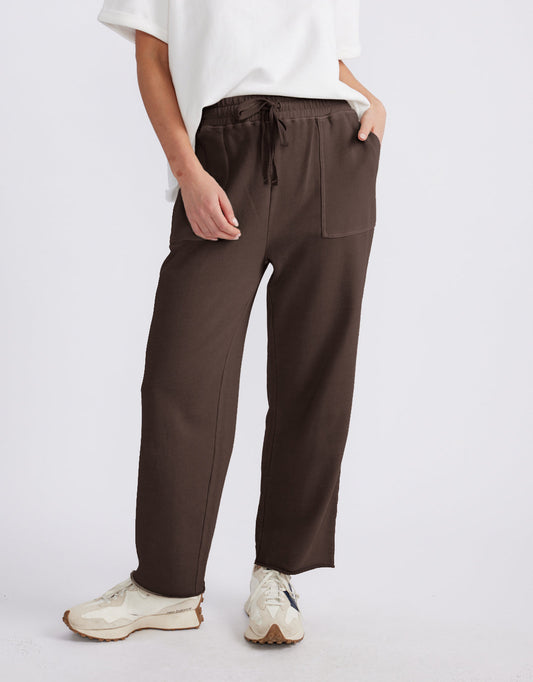 Image of a model wearing Pants. Product name - Raw Edge Lounge Pant Washed Chocolate in Chocolate colour by brand - White & Co.