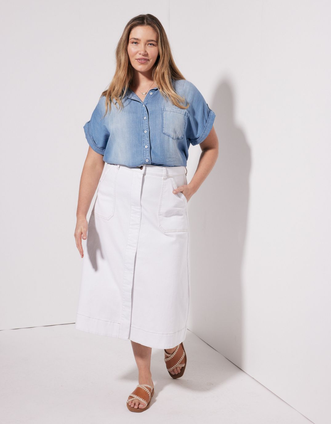 Image of a model wearing Skirts. Productname: Catalina Midi Skirt - in White colour by brand - White & Co.