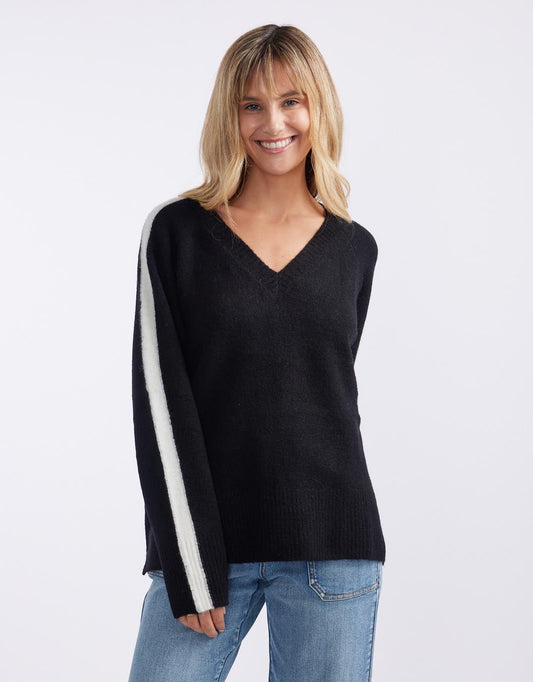 Image of a model wearing Outerwear. Productname: Chalet V Neck Knit Jumper - in Black/White colour by brand - White & Co.