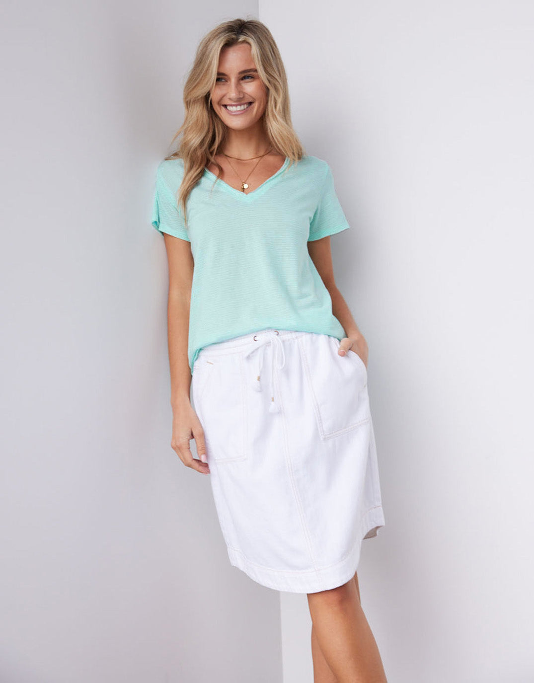 Image of a model wearing Skirts. Productname: Coco Denim Skirt - in White colour by brand - White & Co.