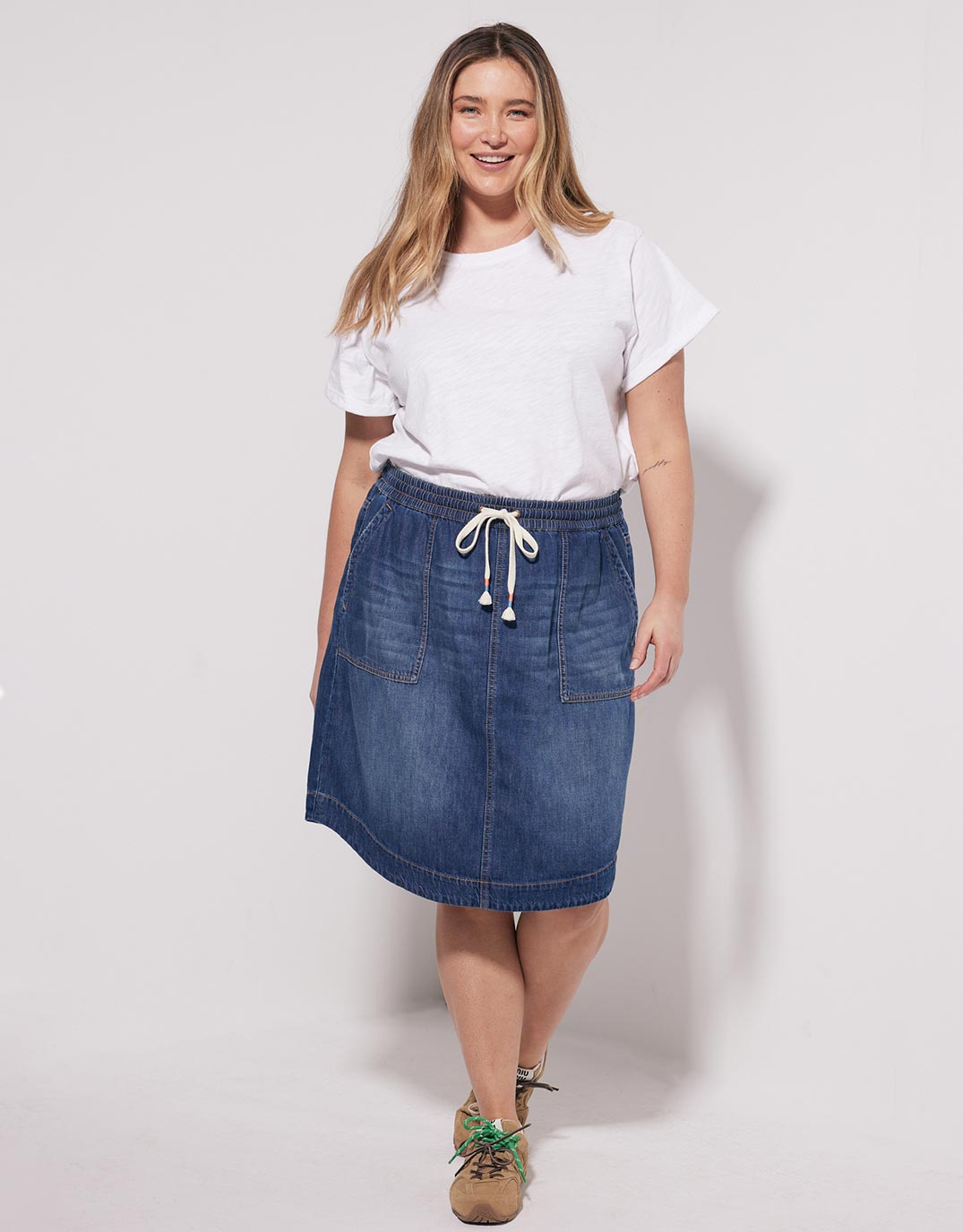 Image of a model wearing Skirts. Productname: Coco Denim Skirt - in Dark Wash colour by brand - White & Co.