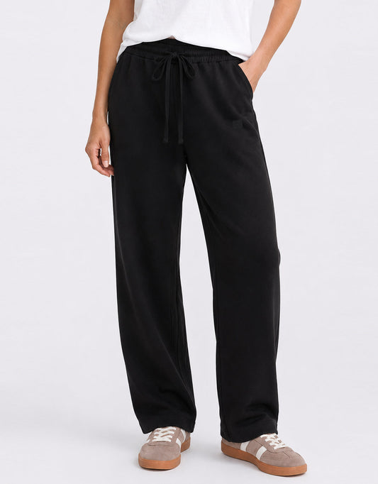Image of a model wearing Pants. Product name - Escape Super Soft Lounge Pant Black in Black colour by brand - White & Co.