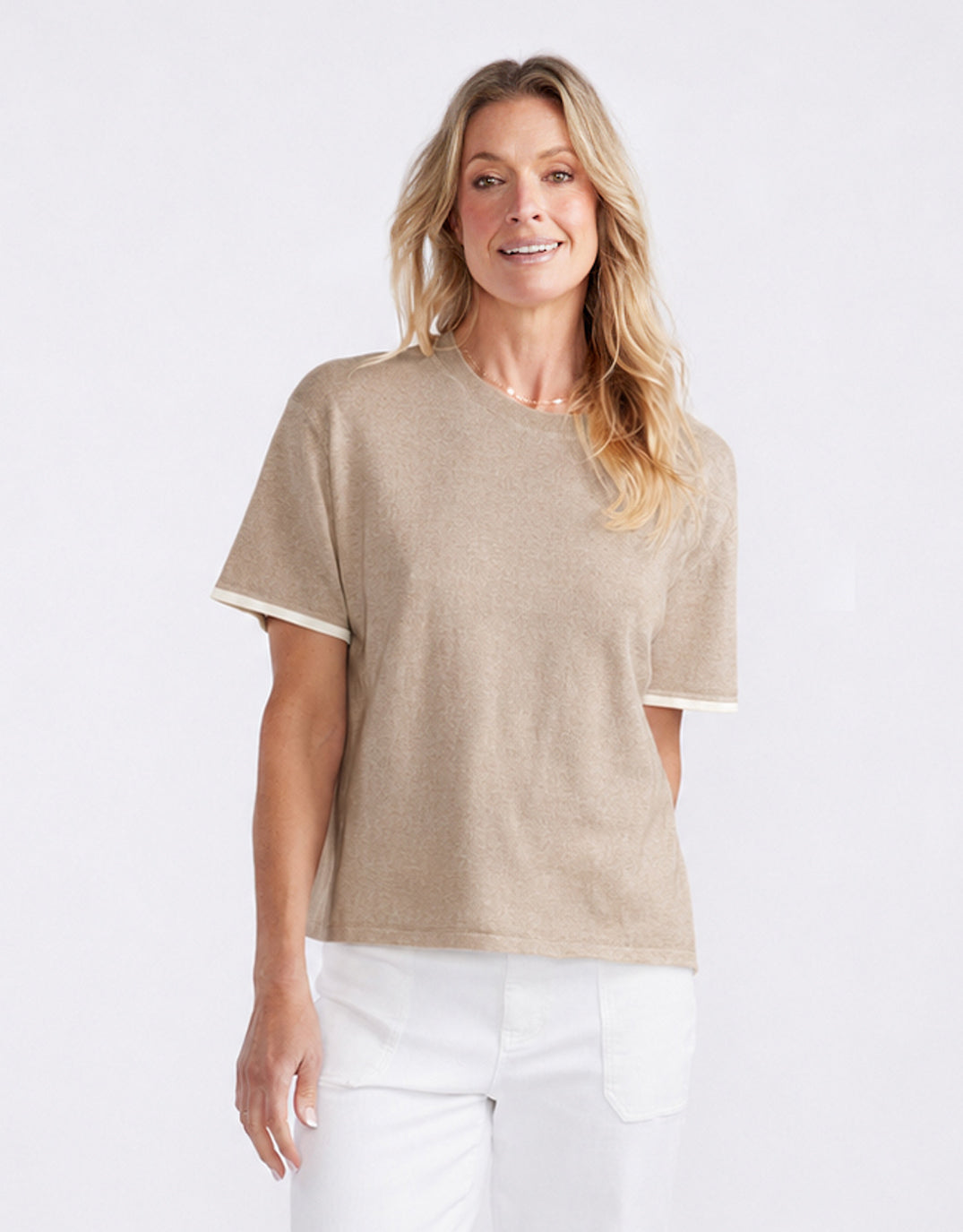 Image of a model wearing Outerwear. Product name - Frenchie Cotton Cashmere Tee Latte in Latte colour by brand - White & Co.