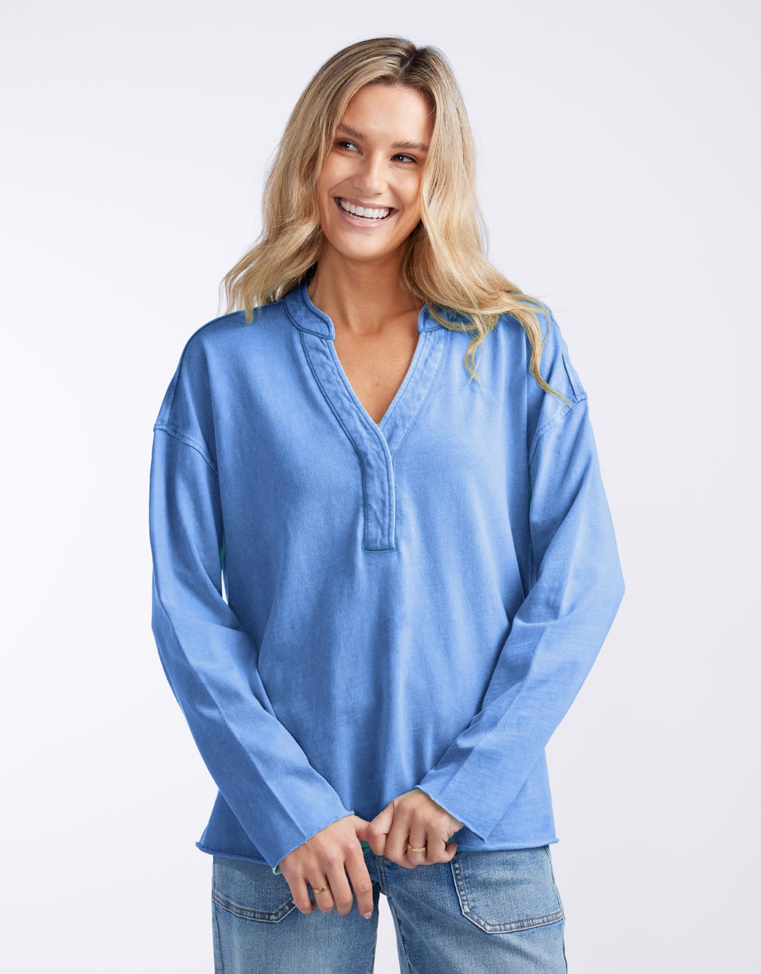 Image of a model wearing Tops. Productname: Henley Sunset Top - in Danish Blue colour by brand - White & Co.