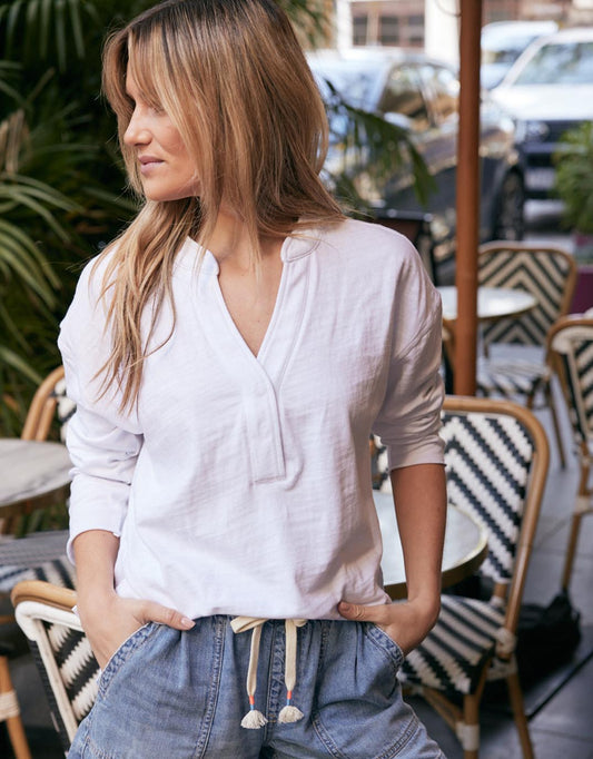 Image of a model wearing Tops. Productname: Henley Sunset Top - in White colour by brand - White & Co.