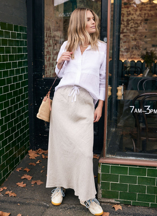 Image of a model wearing Skirts. Product name - Linen Slip Skirt Natural in Natural colour by brand - White & Co.