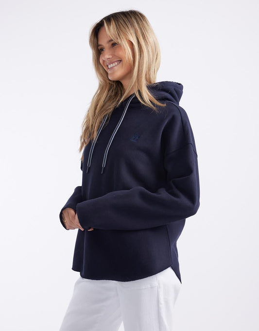 Image of a model wearing Outerwear. Productname: Monogram Fleece Hoodie - in Navy colour by brand - White & Co.