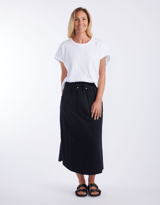 Image of a model wearing Skirts. Productname: Signature Midi Skirt - in Black colour by brand - White & Co.
