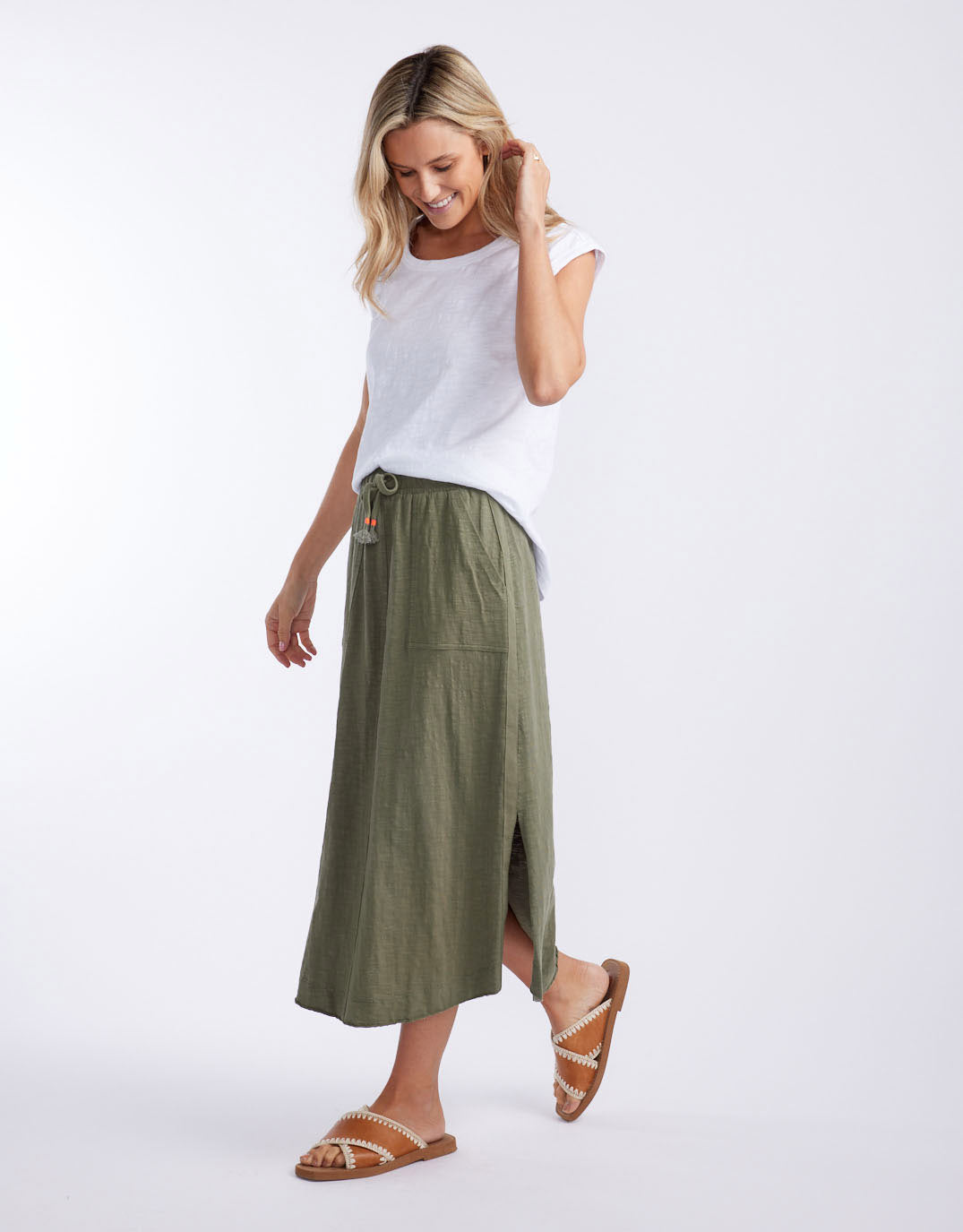 Image of a model wearing Skirts. Productname: Signature Midi Skirt - in Khaki colour by brand - White & Co.