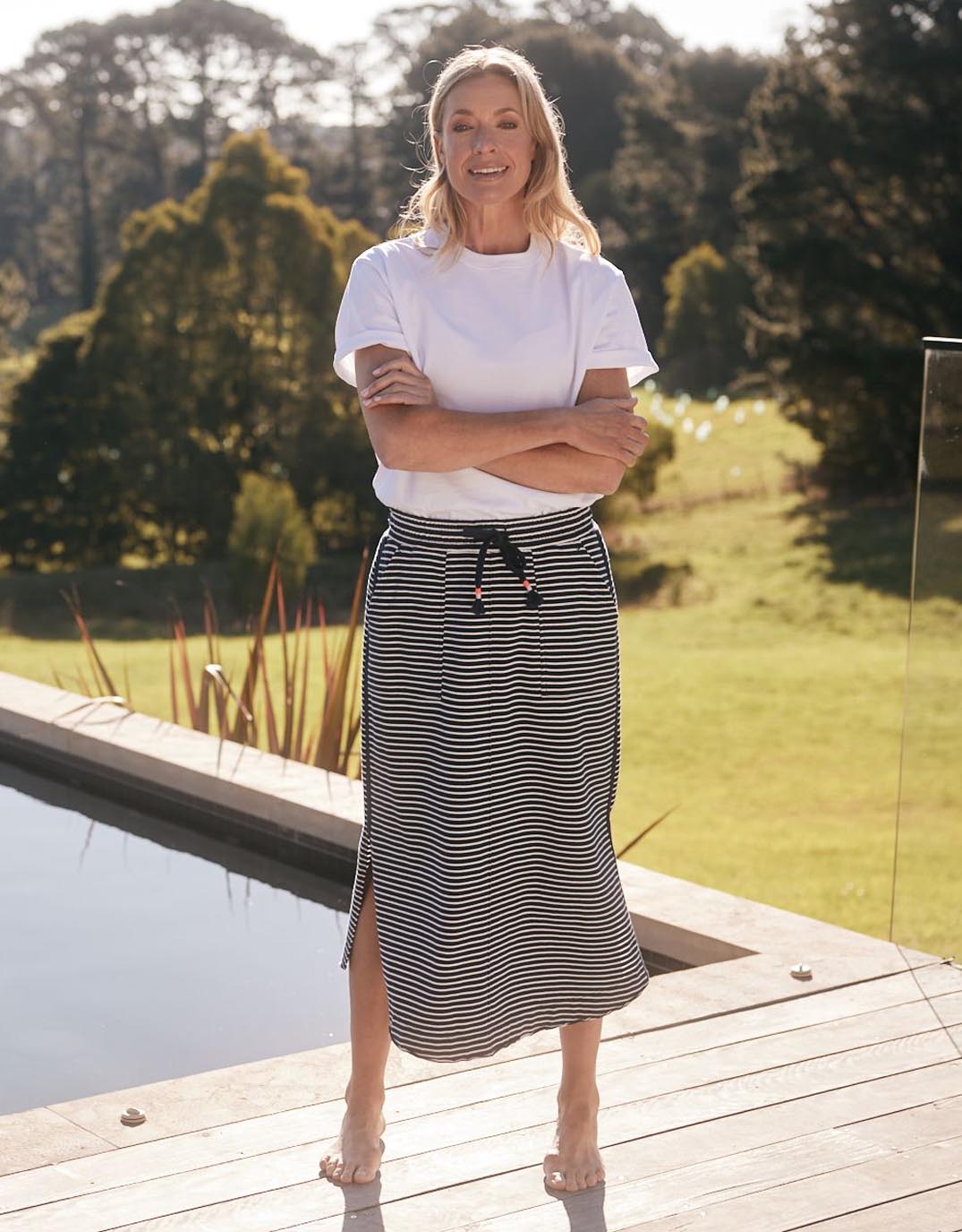 Image of a model wearing Skirts. Productname: Signature Midi Skirt - in Navy/White Stripe colour by brand - White & Co.